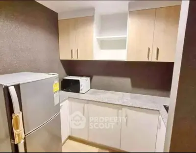 Modern kitchen with sleek cabinets and stainless steel fridge