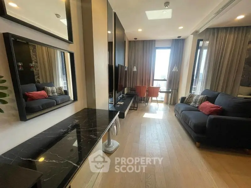 Modern living room with stylish decor and large windows offering natural light