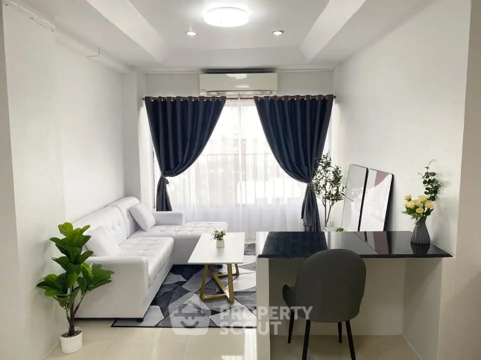 Modern living room with white sofa, elegant curtains, and stylish decor