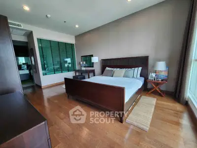 Spacious modern bedroom with wooden flooring and stylish decor