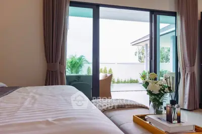 Luxurious bedroom with patio access and elegant decor, perfect for relaxation and comfort.