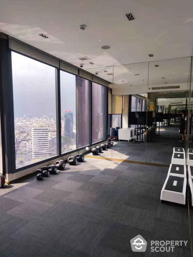 Luxurious high-rise gym with panoramic city views and modern fitness equipment