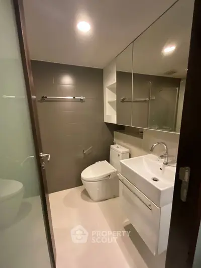 Modern bathroom with sleek fixtures and ample storage space.