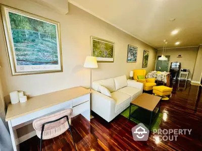 Spacious living room with modern decor, wooden flooring, and cozy seating area.