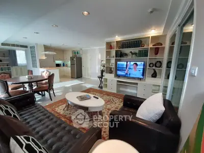 Spacious living room with elegant decor and open kitchen layout in modern apartment.