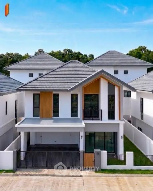 Modern two-story house with sleek design and spacious driveway in a serene neighborhood.