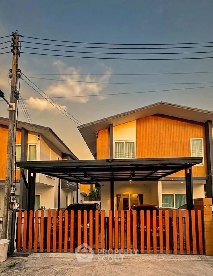 Charming modern house with wooden facade and carport in serene neighborhood at sunset.
