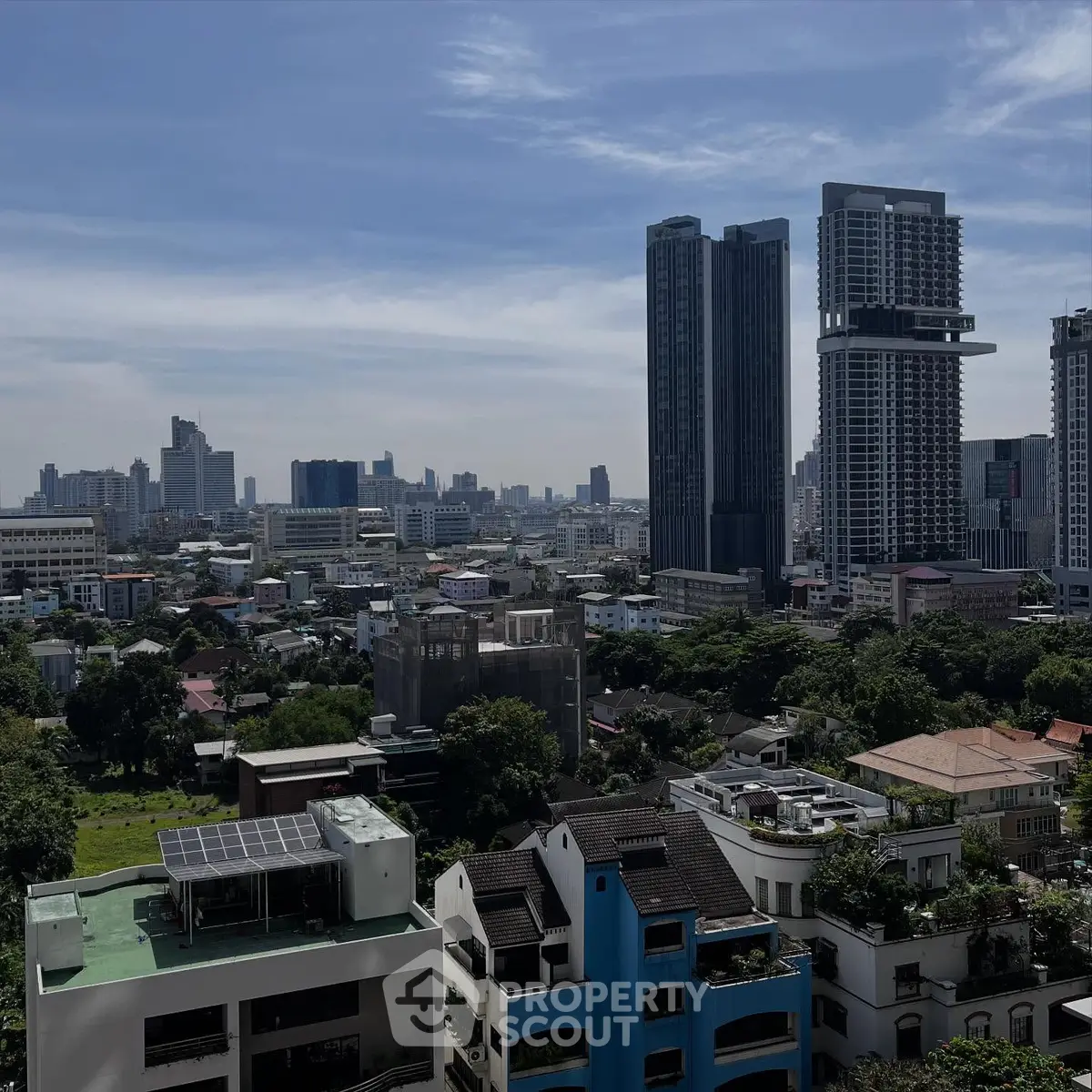 Stunning cityscape view with modern high-rise buildings and lush greenery.