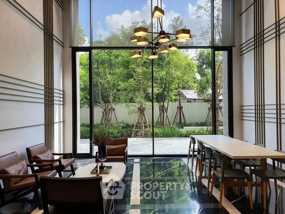 Luxurious modern living room with floor-to-ceiling windows and elegant furniture overlooking a lush garden.