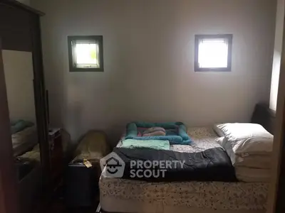 Cozy bedroom with mirrored wardrobe and soft lighting