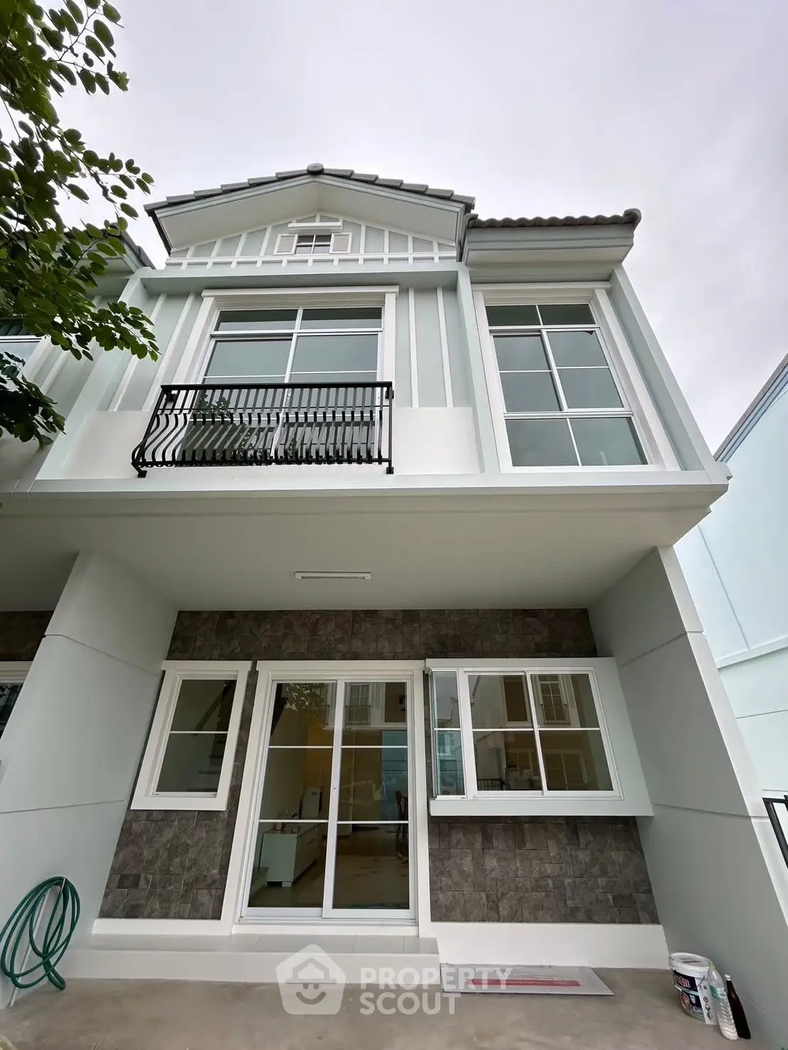 Charming two-story house with elegant facade and large windows, perfect for modern living.