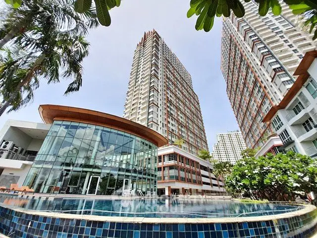 Stunning high-rise residential complex with pool and lush greenery