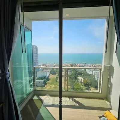 Stunning ocean view from a modern high-rise balcony, perfect for relaxation and enjoying the scenery.
