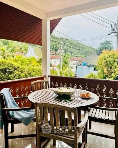 Charming balcony with wooden furniture and scenic view, perfect for relaxation and outdoor dining.