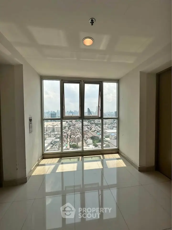 Stunning high-rise view from a modern building corridor with large windows.
