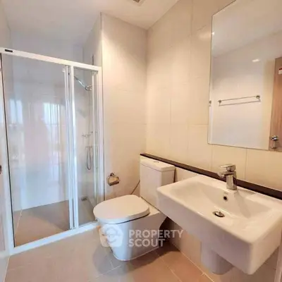 Modern bathroom with sleek fixtures and glass shower enclosure