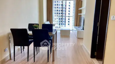 Modern living room with dining area and balcony view in high-rise apartment