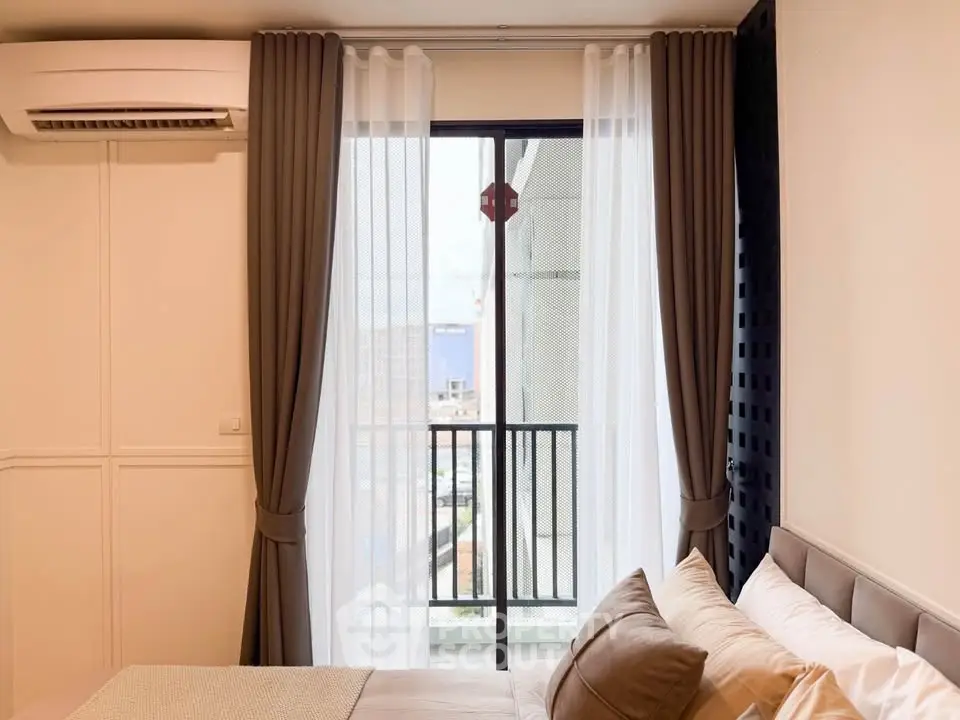 Cozy bedroom with balcony view and air conditioning, perfect for urban living.
