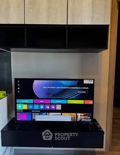 Modern living room with sleek TV setup and stylish storage cabinets.