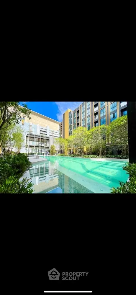 Luxurious modern apartment complex with stunning pool and lush greenery