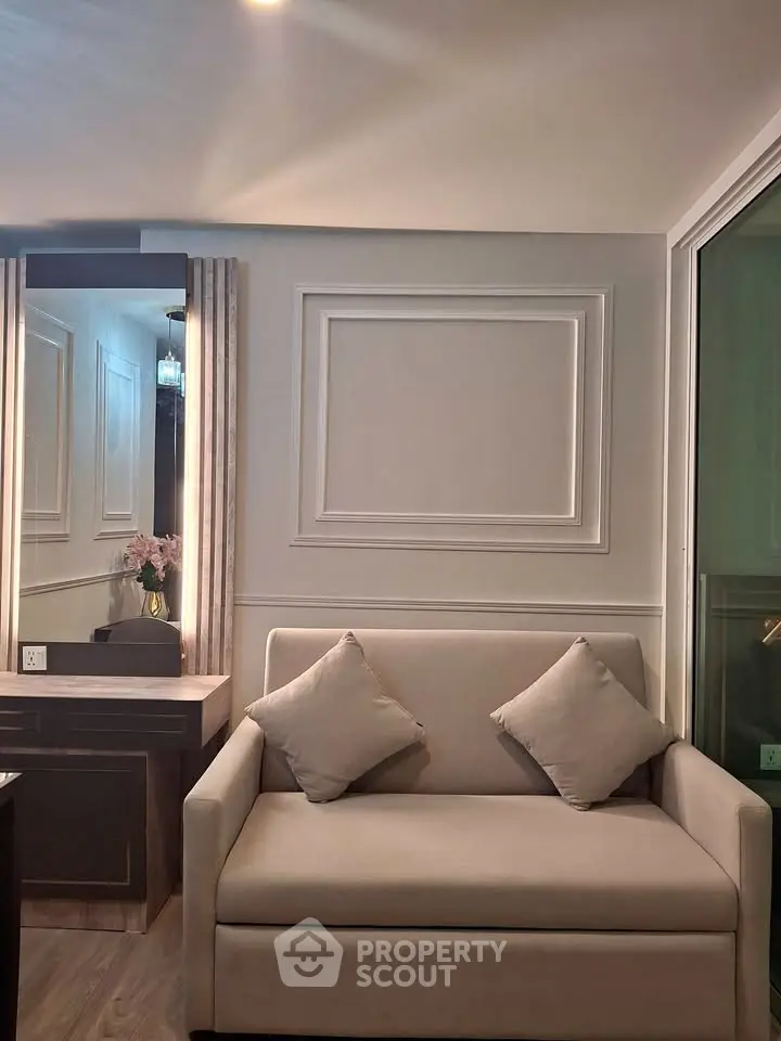 Elegant living room with modern sofa and decorative wall paneling, perfect for stylish urban living.