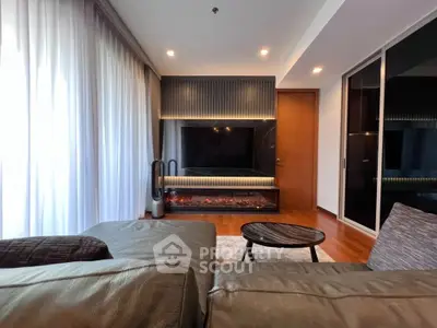 Luxurious living room with modern fireplace and sleek TV setup, perfect for relaxation and entertainment.