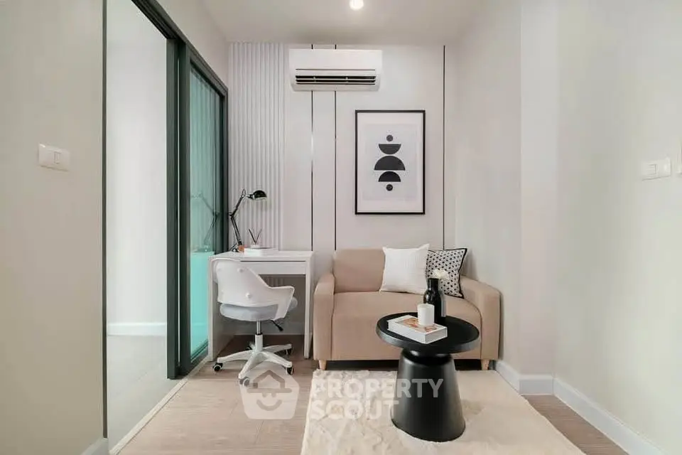 Modern study room with stylish decor and cozy seating in a contemporary apartment.