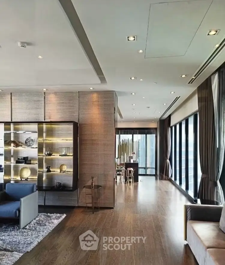 Luxurious modern living room with floor-to-ceiling windows and elegant decor in a high-rise apartment.