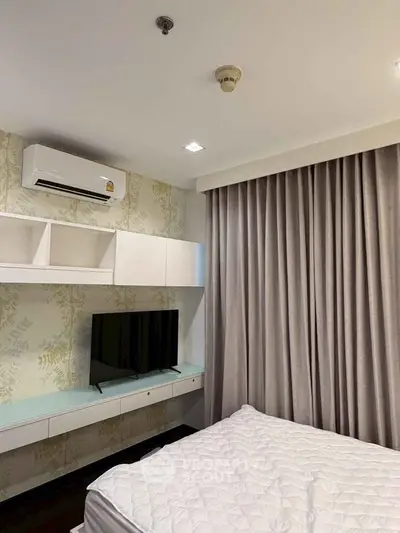 Modern bedroom with air conditioning and stylish curtains