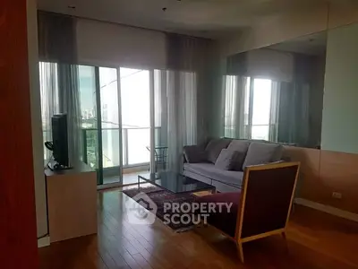 Spacious living room with modern furniture and large balcony view.