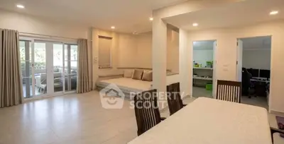 Spacious open-plan living and dining area with modern decor and natural light.