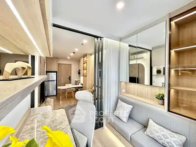 Modern open-plan living room with stylish decor and natural light