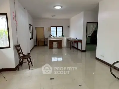 Spacious open-plan living area with natural light and tiled flooring, ideal for customization.