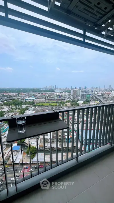 Stunning high-rise balcony view overlooking cityscape and skyline, perfect for urban living.