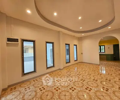 Spacious living room with elegant tile flooring and recessed lighting