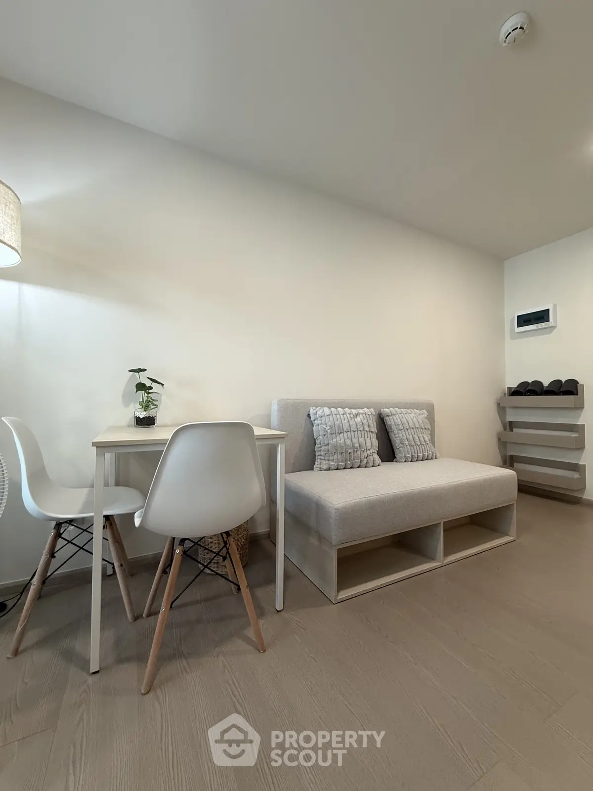 Modern minimalist living room with cozy sofa and dining area