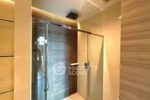 Modern bathroom with glass shower enclosure and elegant tile design