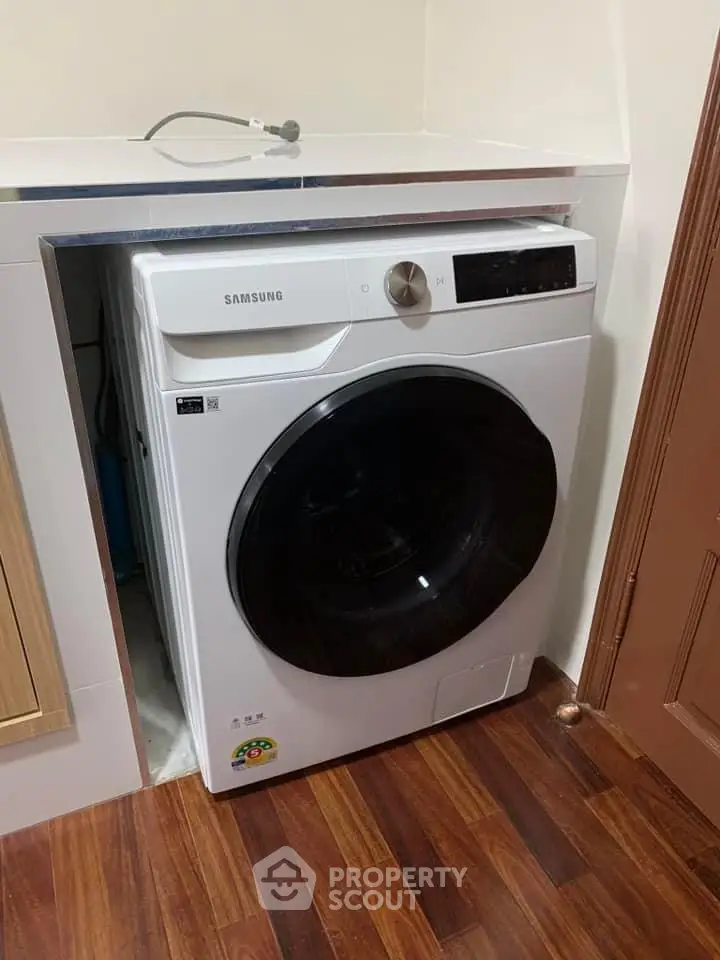 Modern laundry area with Samsung washing machine in compact space