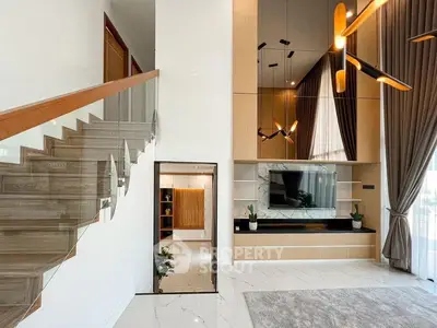Luxurious modern living room with high ceilings and elegant staircase