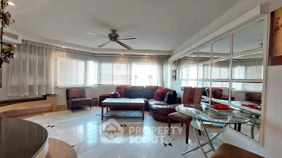 Spacious living room with modern furniture and large windows offering ample natural light.