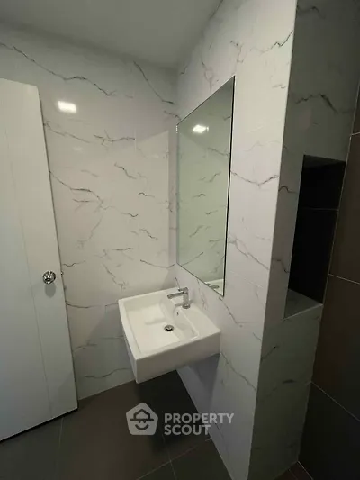 Modern bathroom with sleek sink and marble wall tiles