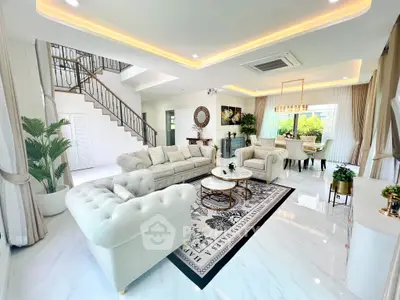 Luxurious open-plan living room with elegant decor and natural light