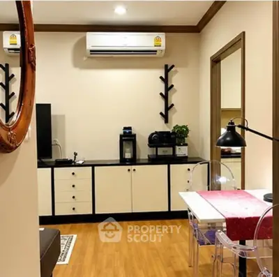 Charming living room with modern decor and air conditioning, featuring a cozy dining area and stylish furniture.