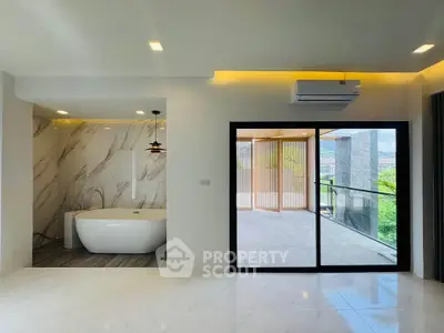 Luxurious open-plan living room with bathtub and balcony view