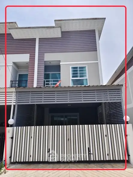 Modern townhouse exterior with sleek design and gated entrance