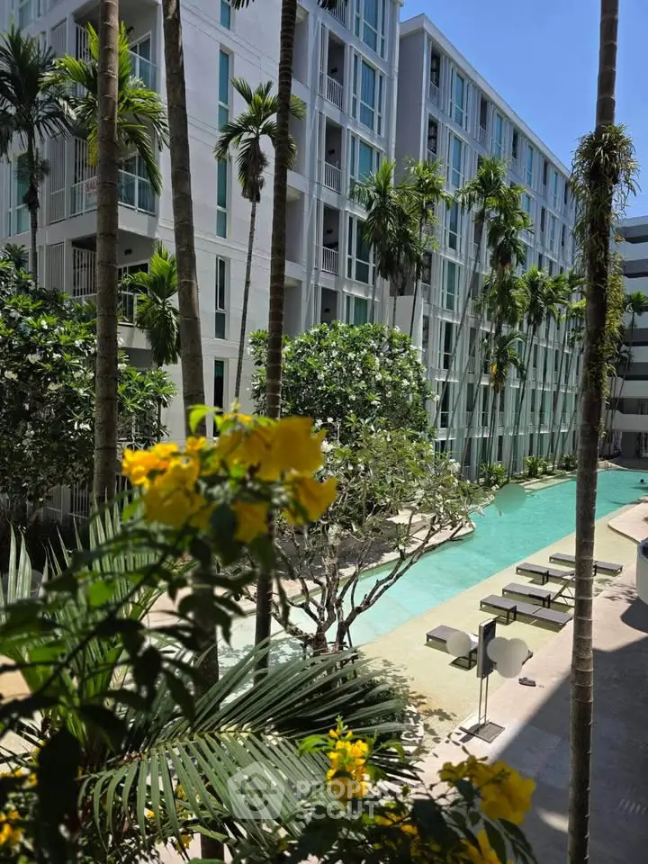 Luxurious apartment complex with stunning pool and lush greenery