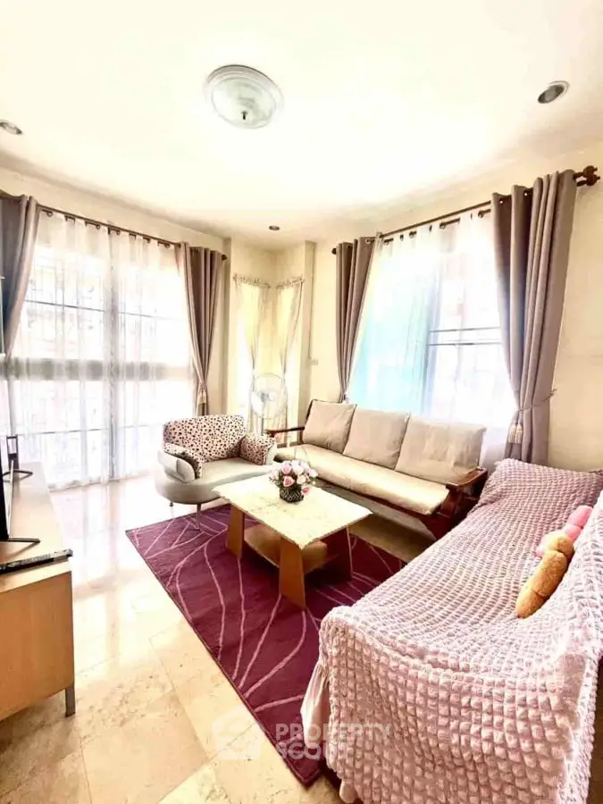 Bright and cozy living room with elegant decor and ample natural light.