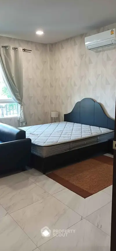 Spacious bedroom with modern decor and natural light