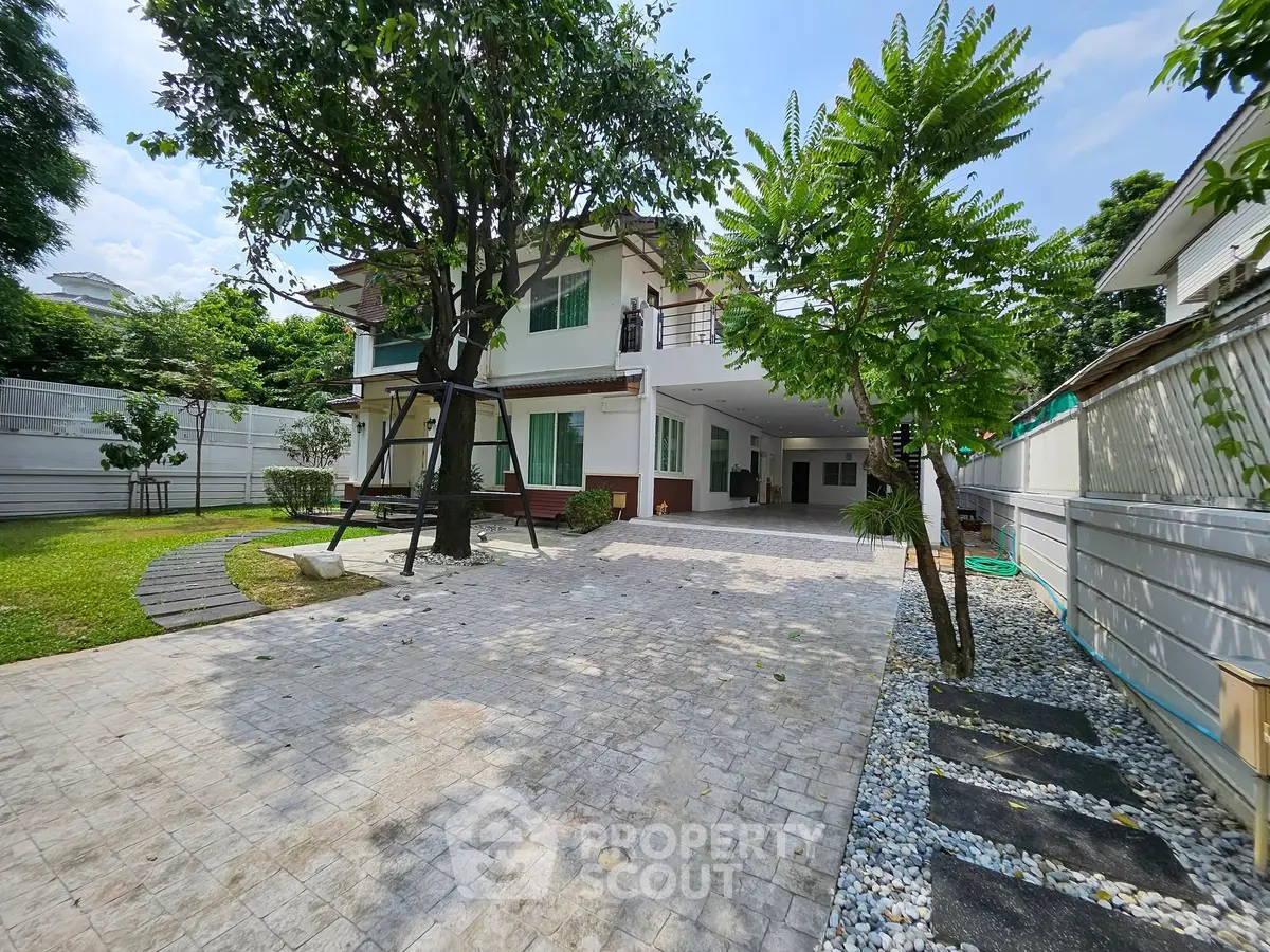 Spacious modern home with large driveway and lush garden, perfect for family living.