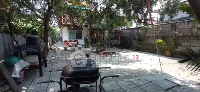 Charming backyard with patio and greenery, perfect for outdoor relaxation and entertainment.